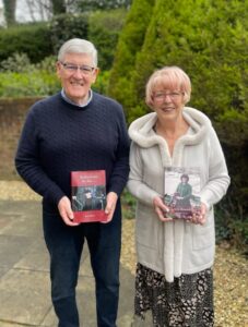 Two smiling LifeBook private autobiography authors holding their LifeBooks.