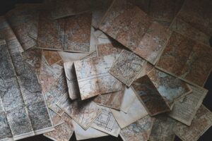 An atmospheric photo of many old maps spread out together.