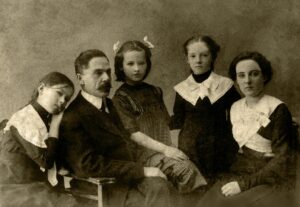 A photograph of what appears to be posed studio picture of a Victorian husband and wife with three daughters.