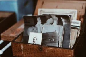 A vintage wooden box containing old family photographs.