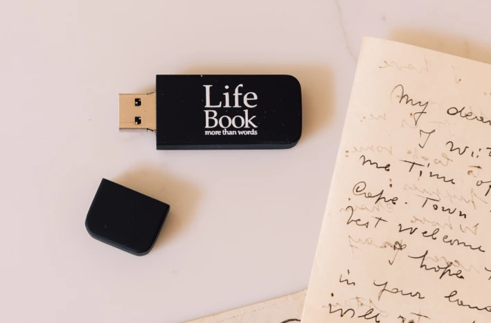 A USB drive next to a hand written note.