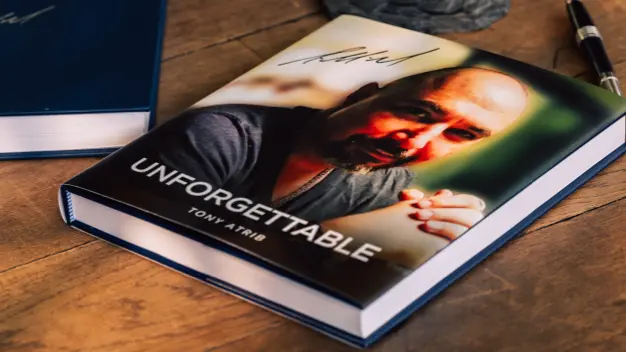 A tribute book on a wooden table.